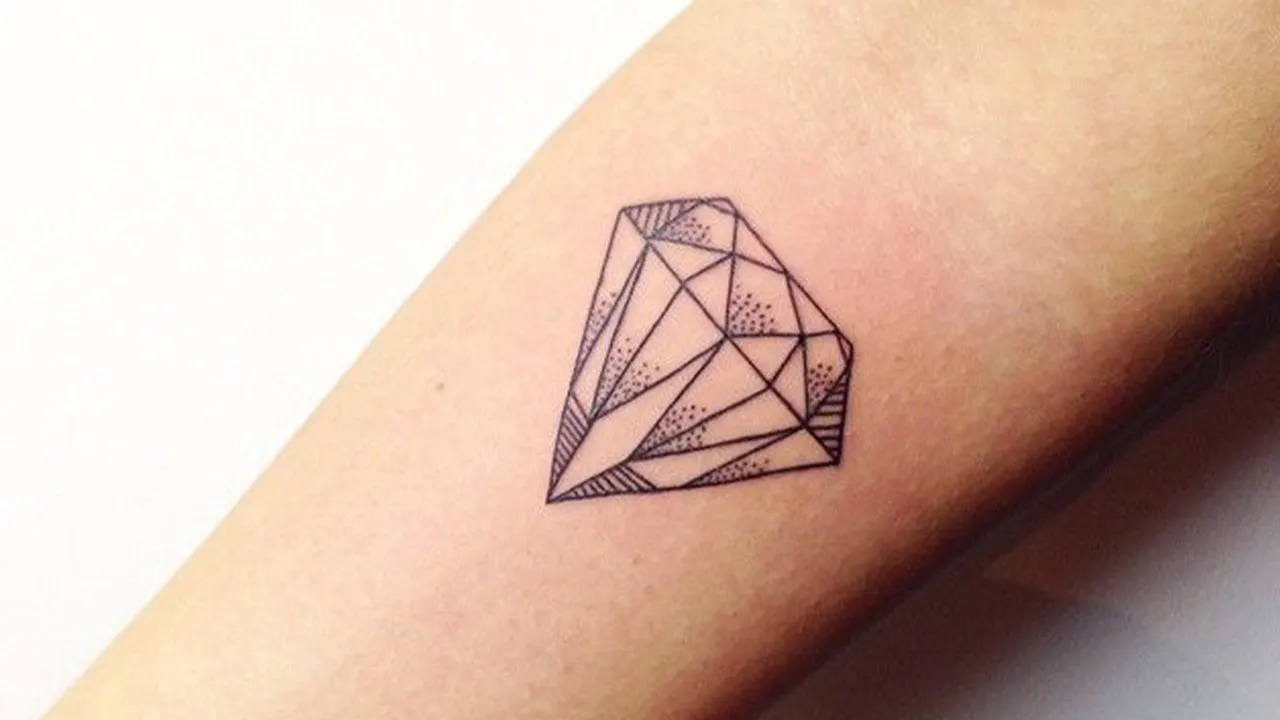 Fine line diamond tattoo located on the inner forearm.